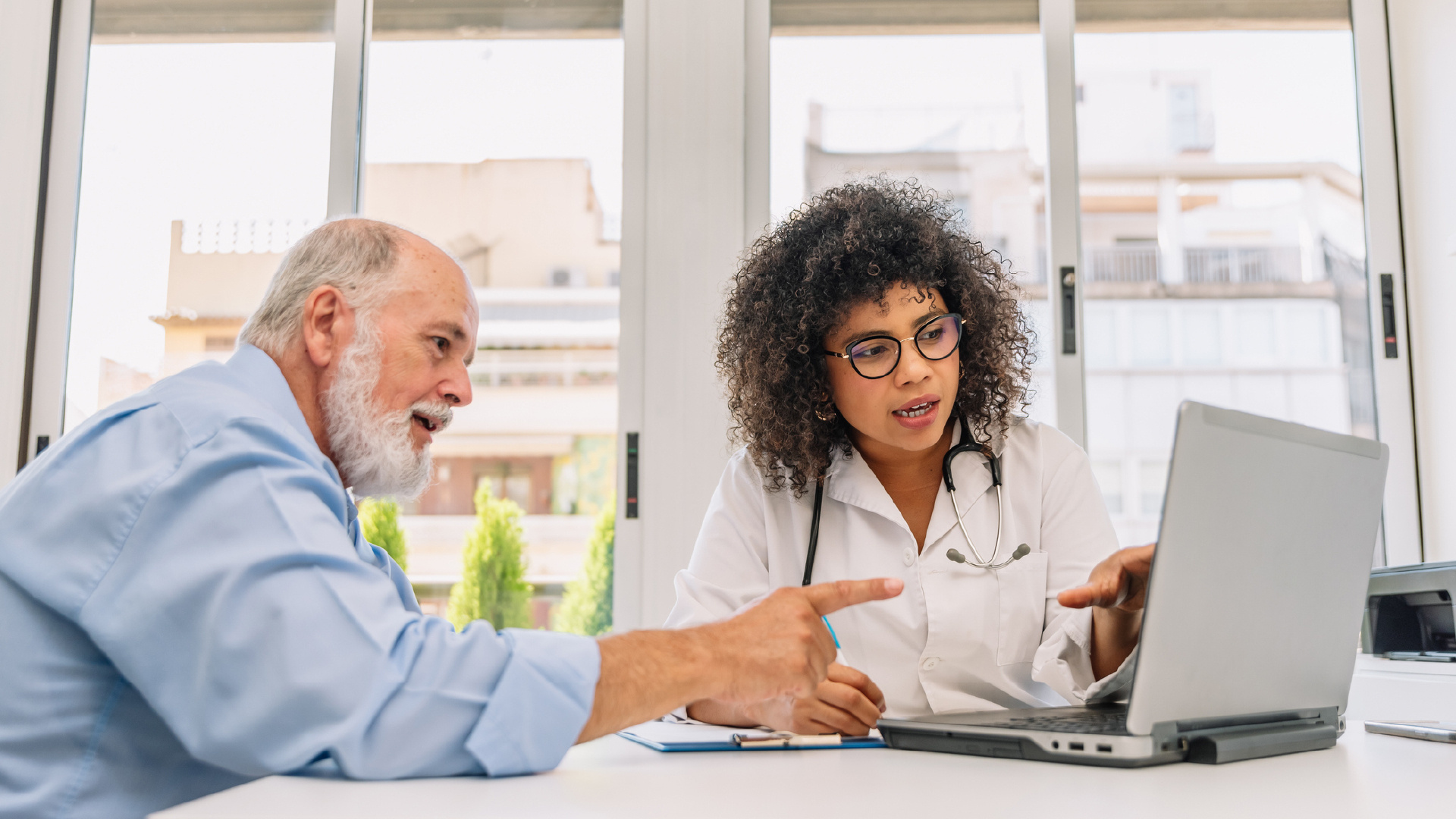 Featured image: Two medical professionals looking at a report together discussing it. - Read full post: AFib Awareness Month: Innovating Cardiac Remote Monitoring for AFib Management